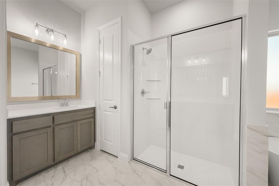 Bathroom featuring marble look tile flooring, a stall shower, and vanity Bathroom featuring marble look tile flooring, a stall shower, and vanity