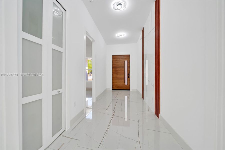 FOYER WITH WATERFALL OF TILE TRIMMED WITH MAHOGANY ACOUSTIC PANELS FOYER WITH WATERFALL OF TILE TRIMMED WITH MAHOGANY ACOUSTIC PANELS