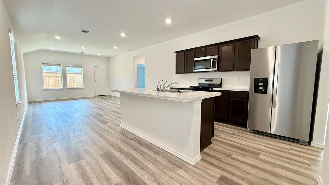 Open-concept living area with a spacious island and bar seating.