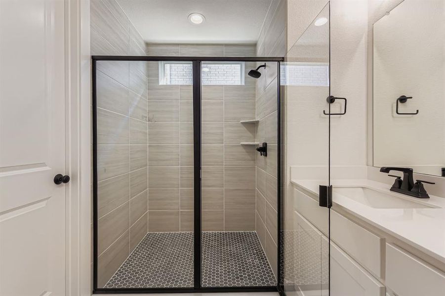 Full bath featuring vanity and a shower stall Full bath featuring vanity and a shower stall