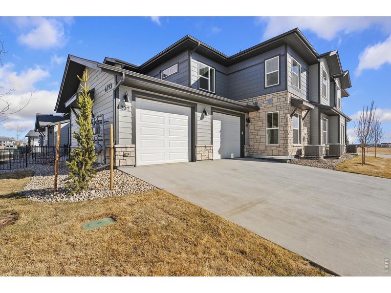 Front exterior of a new home in , Timnath, CO, highlighting curb appeal (Image 1). Front exterior of a new home in , Timnath, CO, highlighting curb appeal (Image 1).
