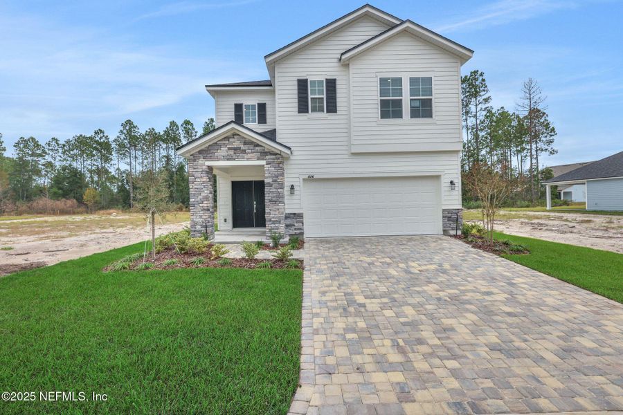 Front exterior of a new home in Brook Forest - Single Family Homes, St. Augustine, FL, highlighting curb appeal (Image 2). Front exterior of a new home in Brook Forest - Single Family Homes, St. Augustine, FL, highlighting curb appeal (Image 2).
