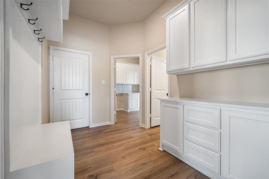 Hall with light wood-style flooring and baseboards