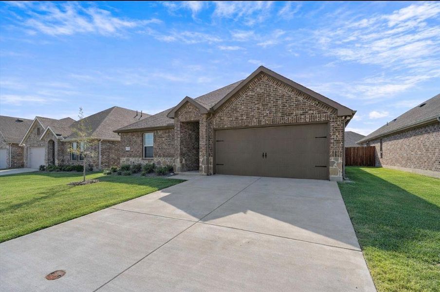 Front exterior of a new home in , Lavon, TX, highlighting curb appeal (Image 15).