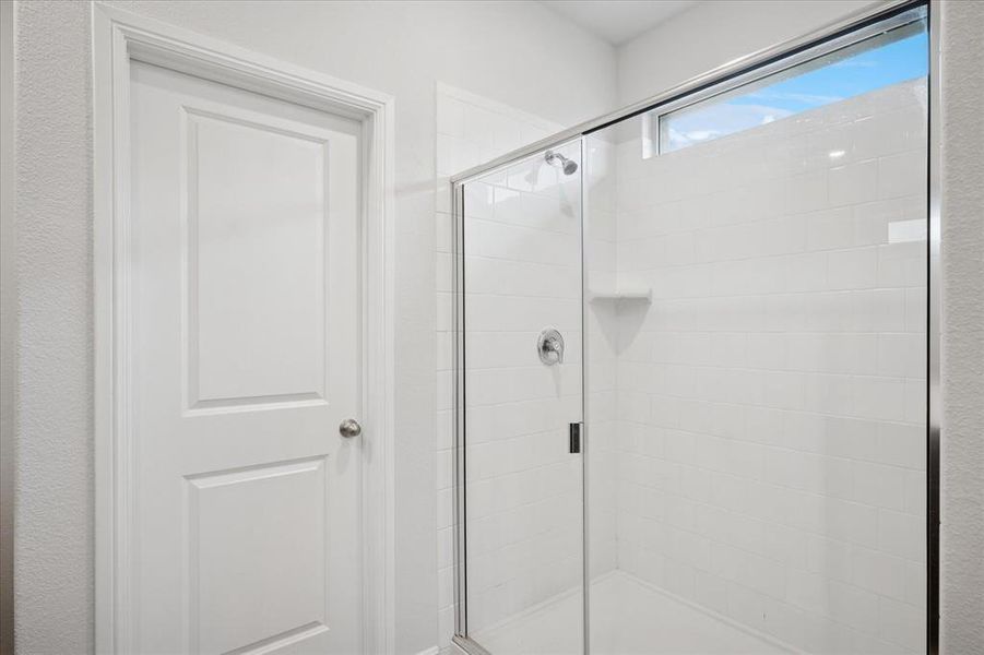 Full bathroom featuring a large shower. Full bathroom featuring a large shower.