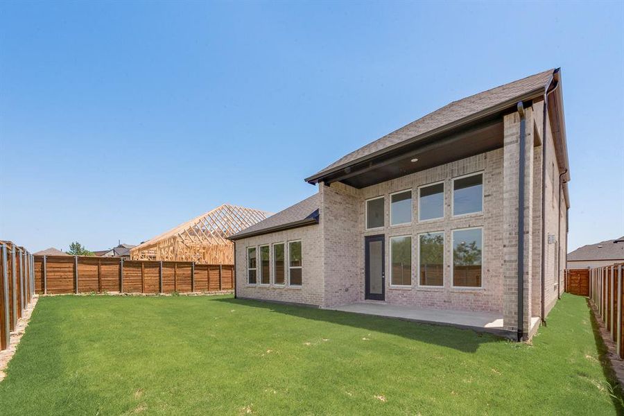 Back of property with brick siding, a fenced backyard, a patio, and roof with shingles Back of property with brick siding, a fenced backyard, a patio, and roof with shingles