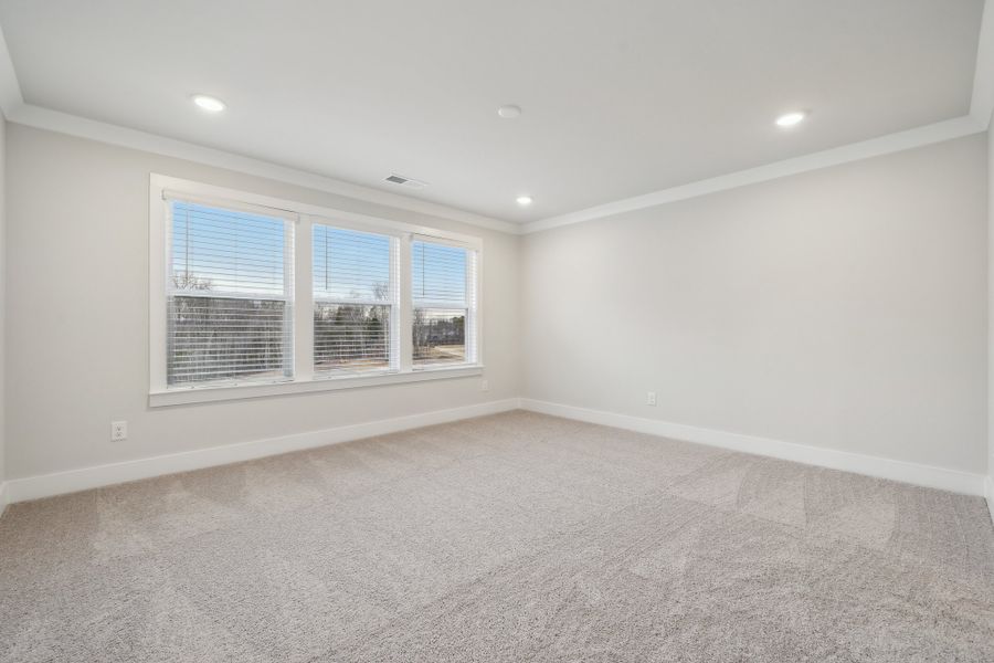 A room with a window and a carpet. A room with a window and a carpet.