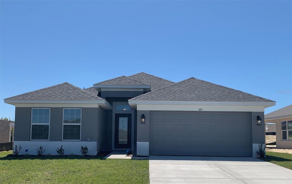 Front exterior of a new home in Twisted Oaks, Beverly Hills, FL, highlighting curb appeal (Image 1). Front exterior of a new home in Twisted Oaks, Beverly Hills, FL, highlighting curb appeal (Image 1).