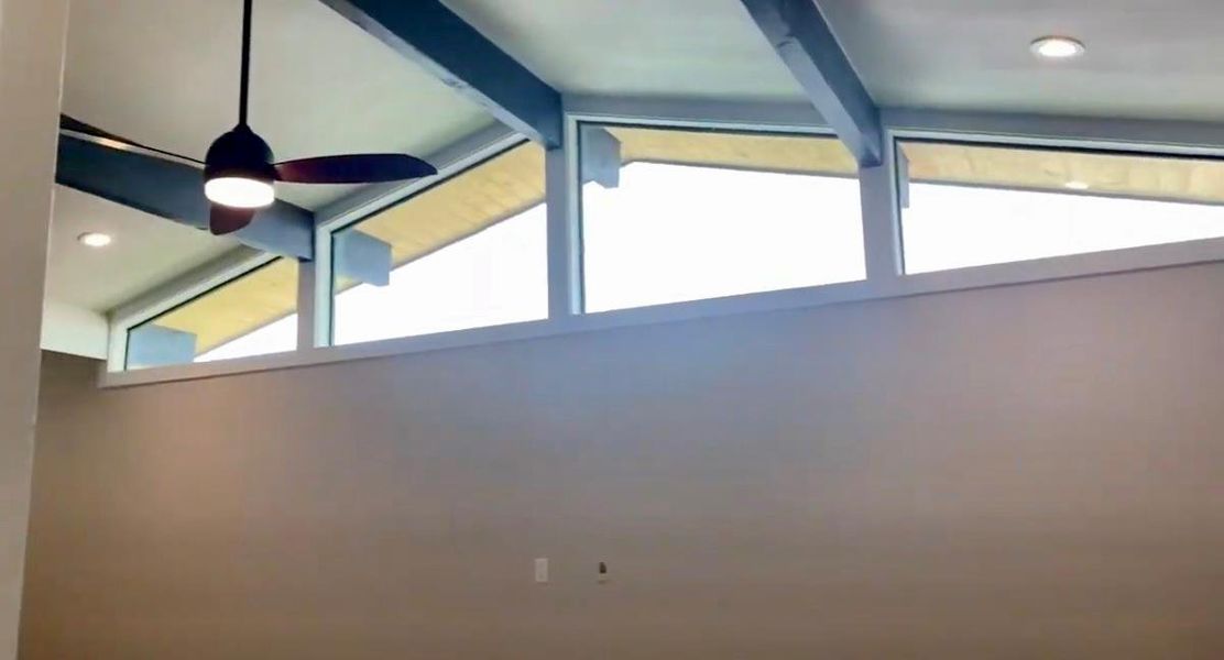 Detailed view of beam ceiling, recessed lighting, and ceiling fan