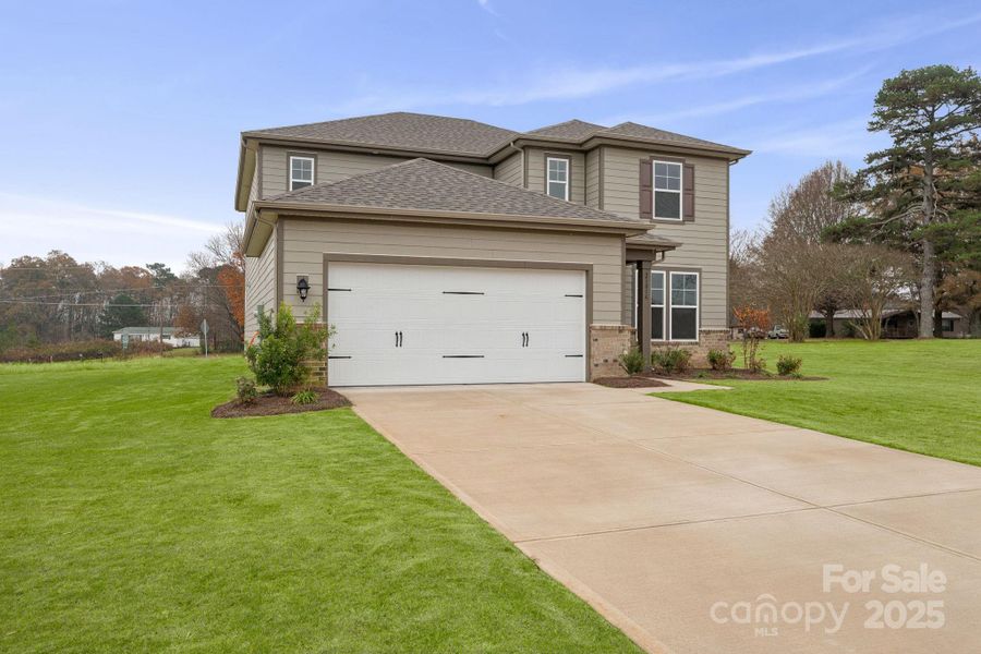 Front exterior of a new home in Running Creek, Locust, NC, highlighting curb appeal (Image 14). Front exterior of a new home in Running Creek, Locust, NC, highlighting curb appeal (Image 14).