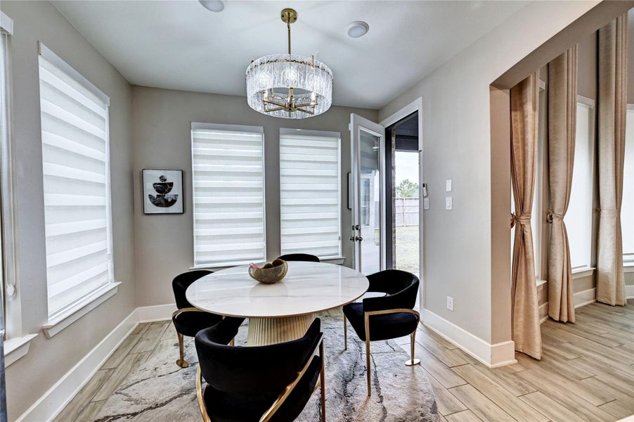 BREAKFAST ROOM WITH CUSTOM BREAKFAST TABLE ,CHAIRS AND CHANDELIERS