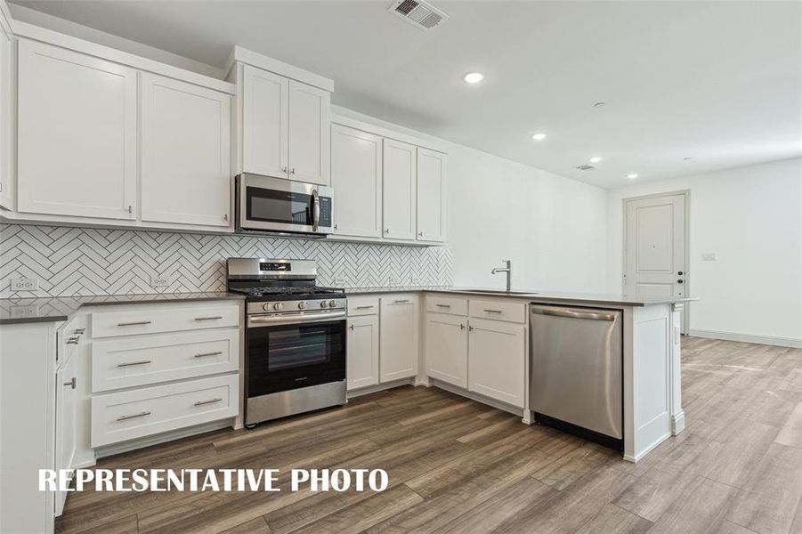 Beautiful finishes paired with a neutral color palette make our Conrad plan kitchen stand out from the crowd!  REPRESENTATIVE PHOTO