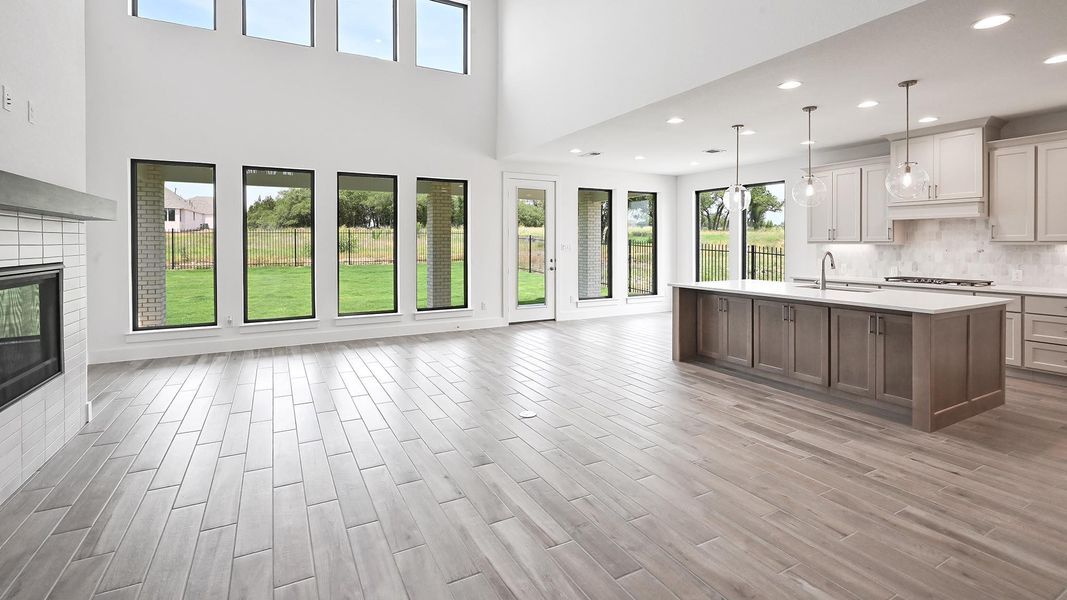 Kitchen featuring open floor plan, a sink, light countertops, gas stovetop, and light wood-style floors Kitchen featuring open floor plan, a sink, light countertops, gas stovetop, and light wood-style floors