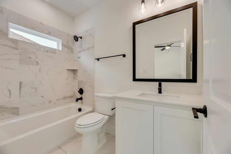 Full bathroom with bathing tub / shower combination and vanity Full bathroom with bathing tub / shower combination and vanity