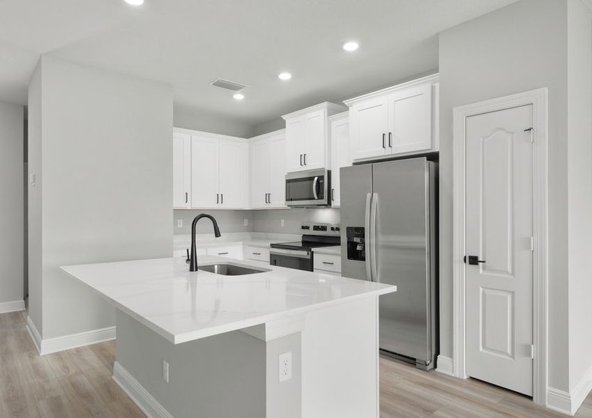 Kitchen with white quartz countertops, white cabinets and matte hardware Kitchen with white quartz countertops, white cabinets and matte hardware