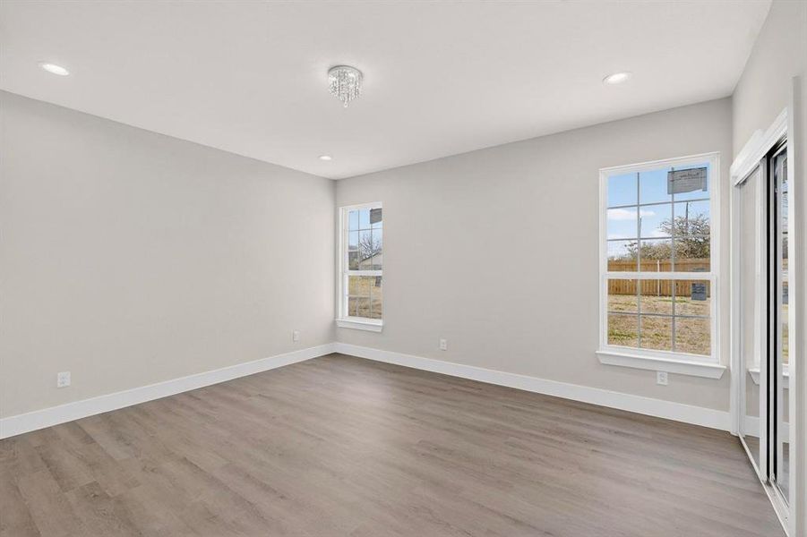 Room with light wood finished floors and recessed lighting Room with light wood finished floors and recessed lighting