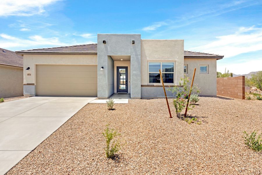Front exterior of a new home in Tavira at Twin Peaks, Marana, AZ, highlighting curb appeal (Image 1). Front exterior of a new home in Tavira at Twin Peaks, Marana, AZ, highlighting curb appeal (Image 1).
