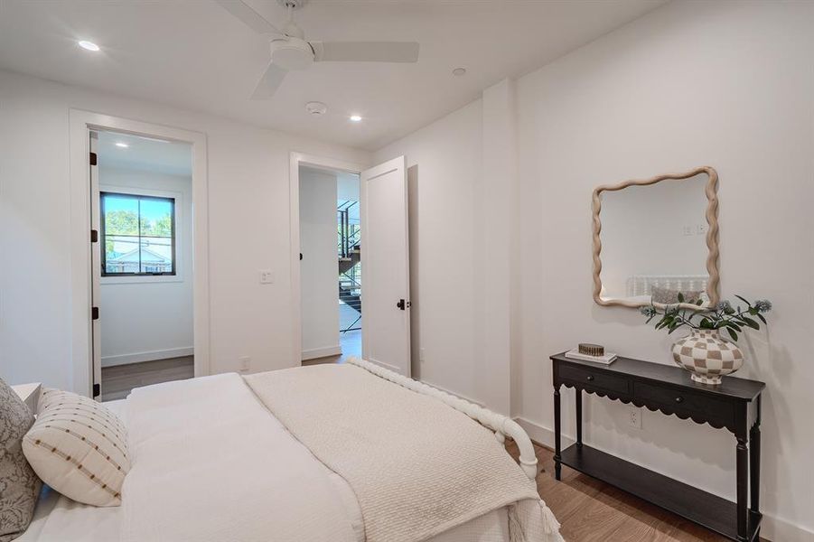 Bedroom featuring wood finished floors, recessed lighting, and ceiling fan Bedroom featuring wood finished floors, recessed lighting, and ceiling fan