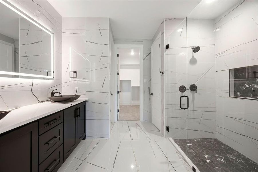 Contemporary bathroom featuring a spacious walk-in shower with clear glass enclosure and hexagon-tiled floor Contemporary bathroom featuring a spacious walk-in shower with clear glass enclosure and hexagon-tiled floor