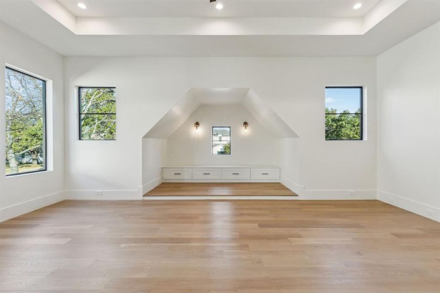 Additional living space featuring plenty of natural light and light hardwood / wood-style flooring