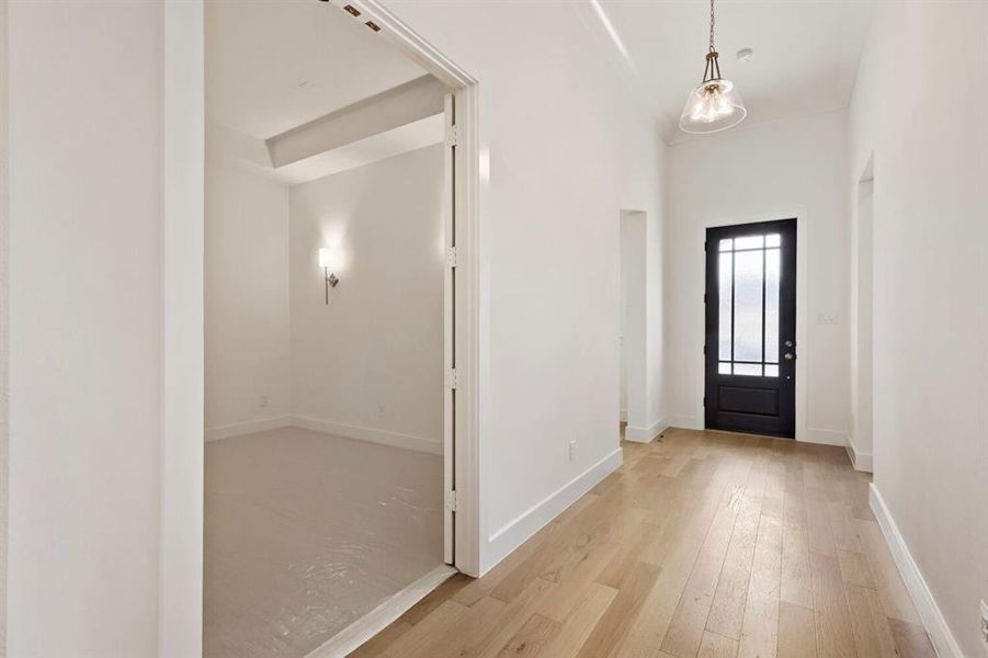 Entrance foyer with light wood-type flooring and baseboards