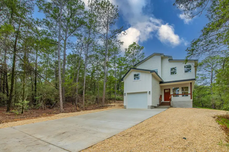 A newly constructed modern dwelling emerges from a dense, verdant woodland, offering a secluded retreat. A newly constructed modern dwelling emerges from a dense, verdant woodland, offering a secluded retreat.
