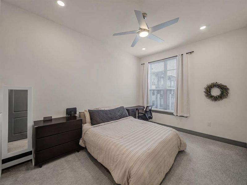 Bedroom with carpet, a ceiling fan, and recessed lighting Bedroom with carpet, a ceiling fan, and recessed lighting