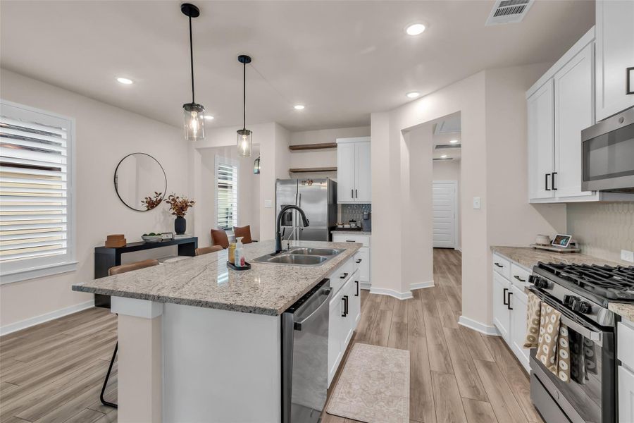 Contemporary lighting and a dining area enhance the space's appeal. Contemporary lighting and a dining area enhance the space's appeal.