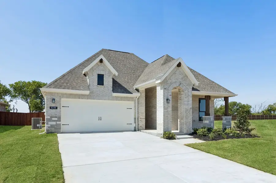 Front exterior of a new home in Parkmont – Timberbrook, Justin, TX, highlighting curb appeal (Image 2). Front exterior of a new home in Parkmont – Timberbrook, Justin, TX, highlighting curb appeal (Image 2).