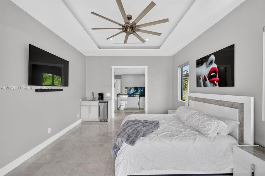 Primary bedroom suite w/ french doors, morning bar, en suite walk in closet and spa bathroom. Sliders lead to private balcony looking down the river