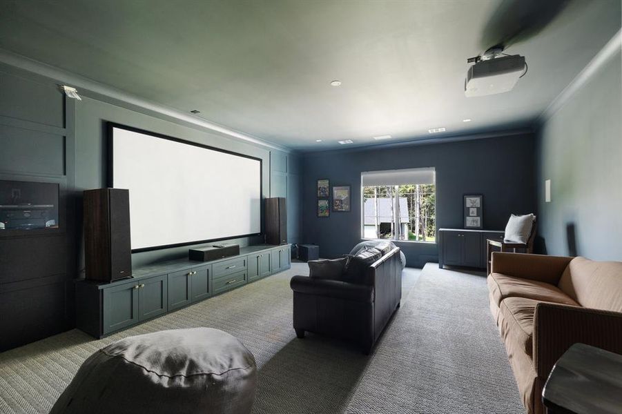 Upstairs media room with blackout shades, sound reducing insulation, movie screen & in wall speakers.