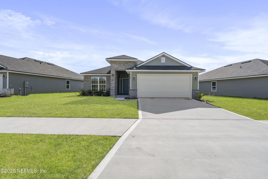 Front exterior of a new home in Summerglen, Jacksonville, FL, highlighting curb appeal (Image 27).