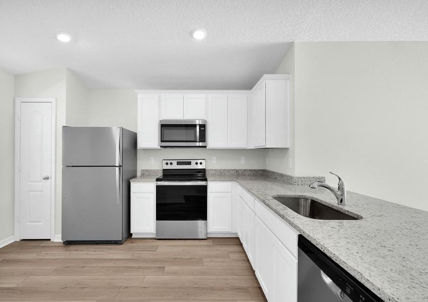 Enjoy stunning granite countertops and designer wood cabinetry in this kitchen