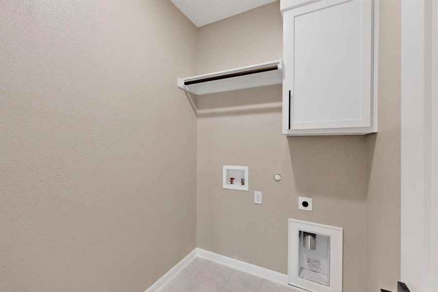 Laundry room with gas dryer hookup, hookup for a washing machine, light tile patterned flooring, hookup for an electric dryer, and cabinet space Laundry room with gas dryer hookup, hookup for a washing machine, light tile patterned flooring, hookup for an electric dryer, and cabinet space