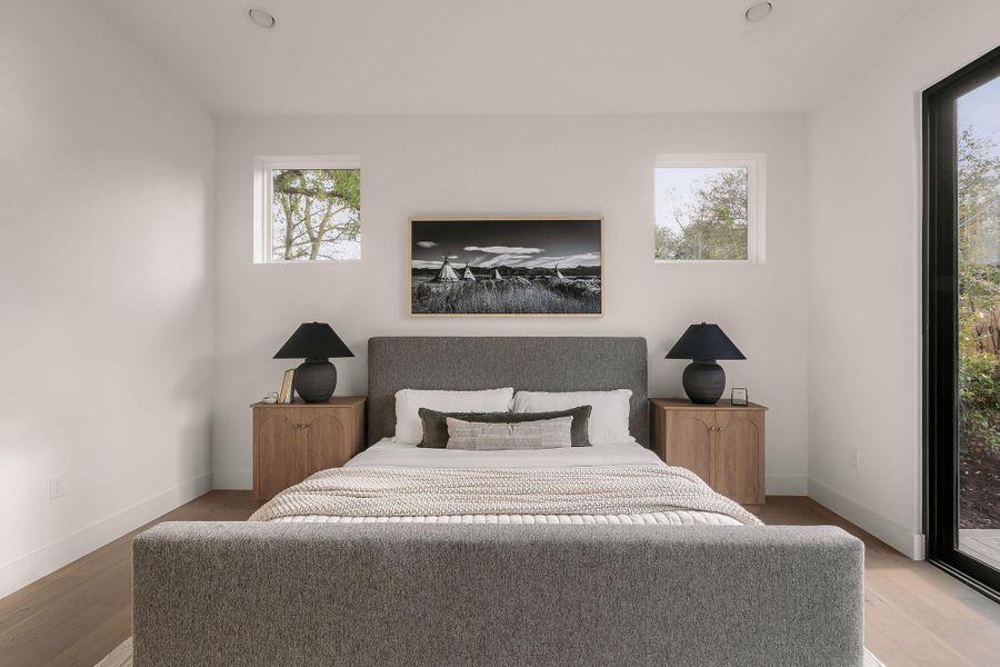 Bedroom with access to outside and light wood-style floors Bedroom with access to outside and light wood-style floors