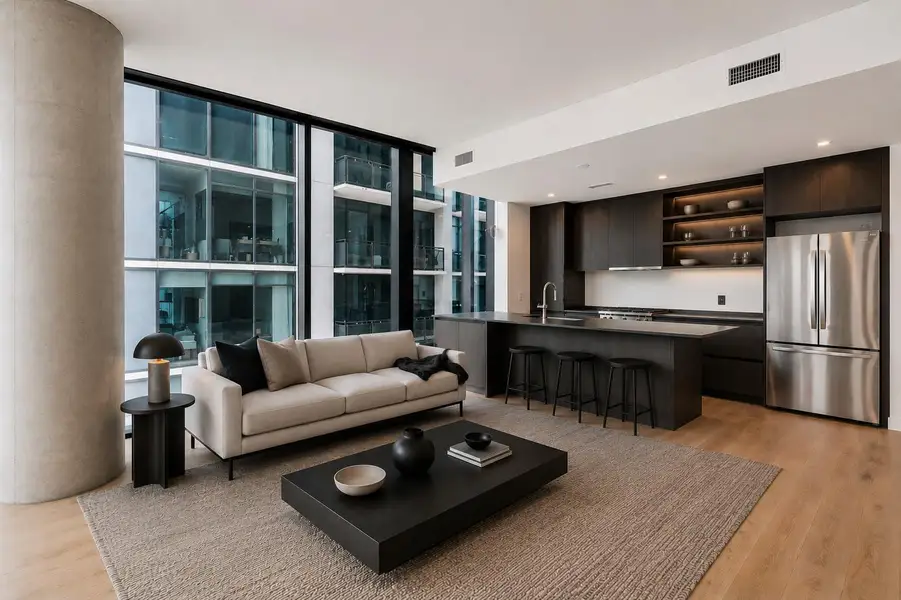Images shown are virtually staged. Floor-to-ceiling windows and wood flooring define this modern open-concept space. Images shown are virtually staged. Floor-to-ceiling windows and wood flooring define this modern open-concept space.