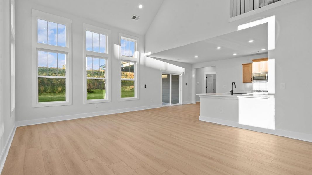 Refined and memorable, this family room features two-story ceilings and top-notch comfort throughout