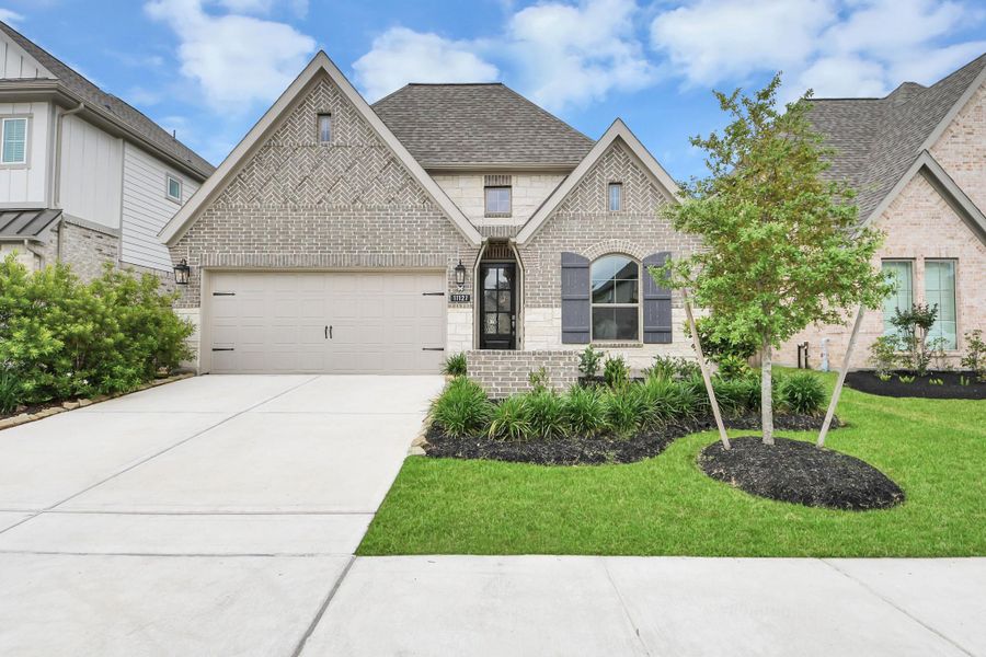 Front exterior of a new home in Bridgeland, Cypress, TX, highlighting curb appeal (Image 23). Front exterior of a new home in Bridgeland, Cypress, TX, highlighting curb appeal (Image 23).