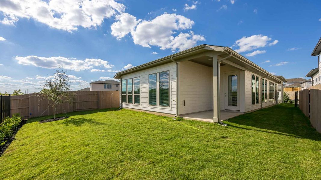 Rear view of property with a fenced backyard and a patio area Rear view of property with a fenced backyard and a patio area