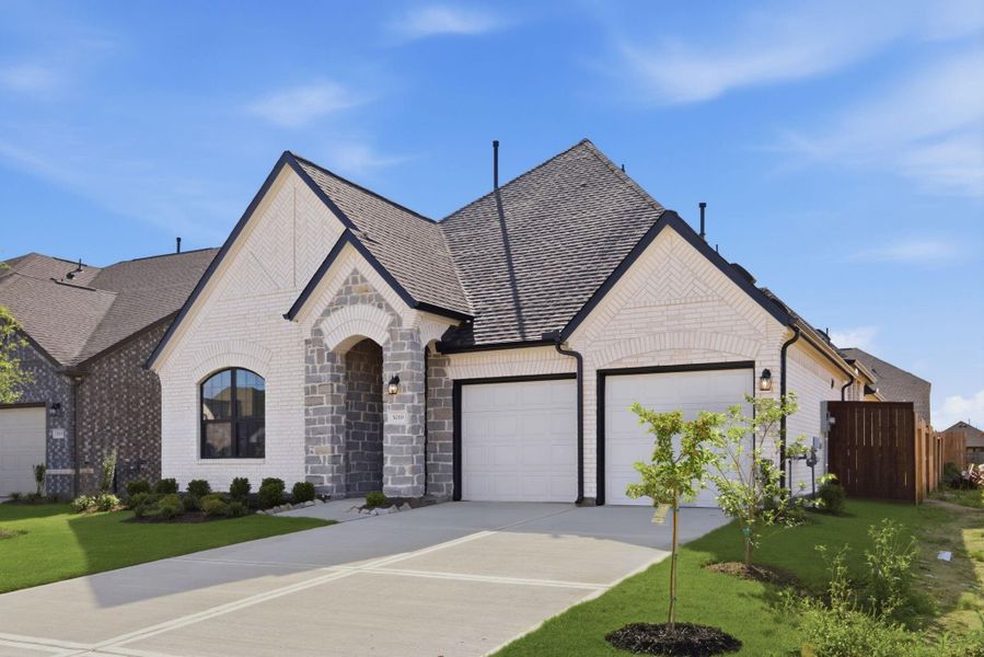 Front exterior of a new home in Brookewater, Rosenberg, TX, highlighting curb appeal (Image 21). Front exterior of a new home in Brookewater, Rosenberg, TX, highlighting curb appeal (Image 21).