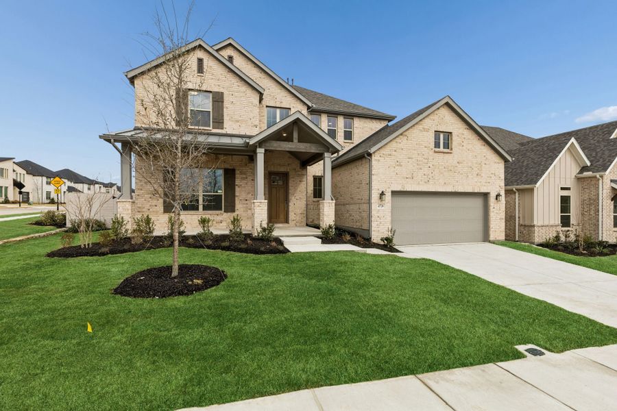 Front exterior of a new home in Painted Tree Lakeside, McKinney, TX, highlighting curb appeal (Image 2). Front exterior of a new home in Painted Tree Lakeside, McKinney, TX, highlighting curb appeal (Image 2).