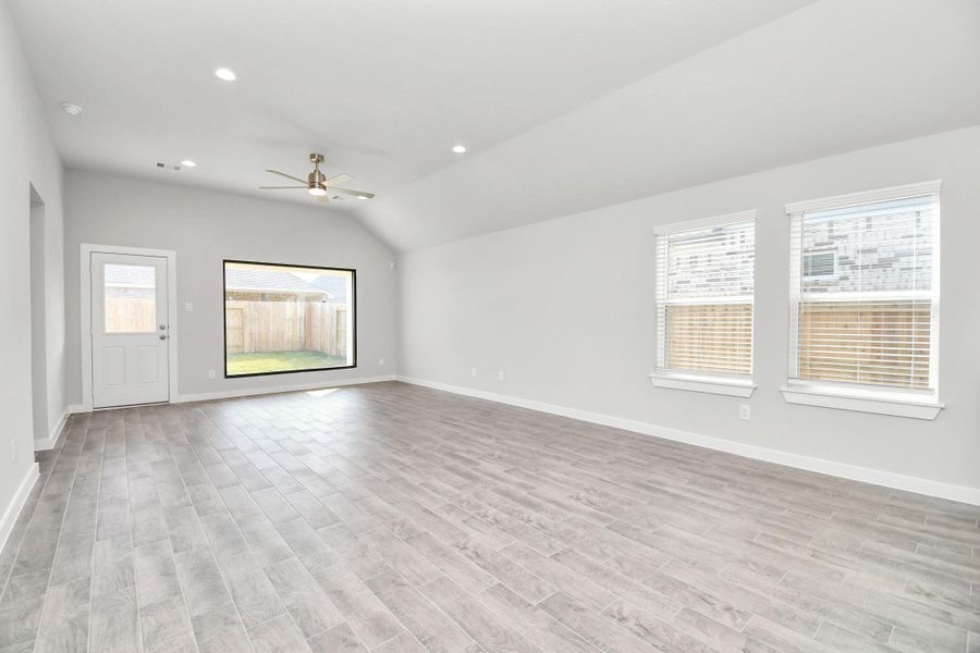 Bring your loved ones and guests together in the inviting famiy room! Boasting lofty high ceilings, recessed lighting, a stylish ceiling fan, custom paint, stunning flooring, and expansive windows that flood the space with ample natural light all day long.