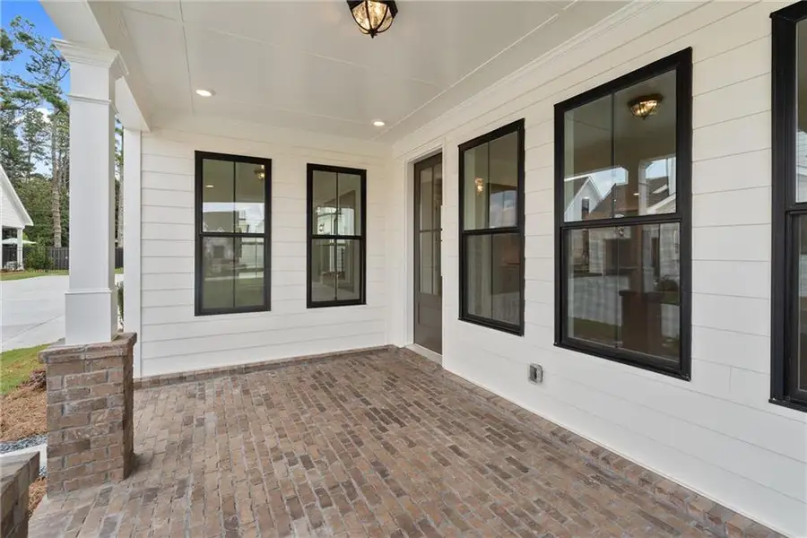Exterior details and patio area of a home in Promenade at Sawnee Village, Cumming (Image 23).