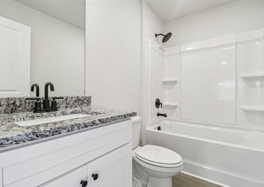 The secondary bathroom has a large soaking tub.