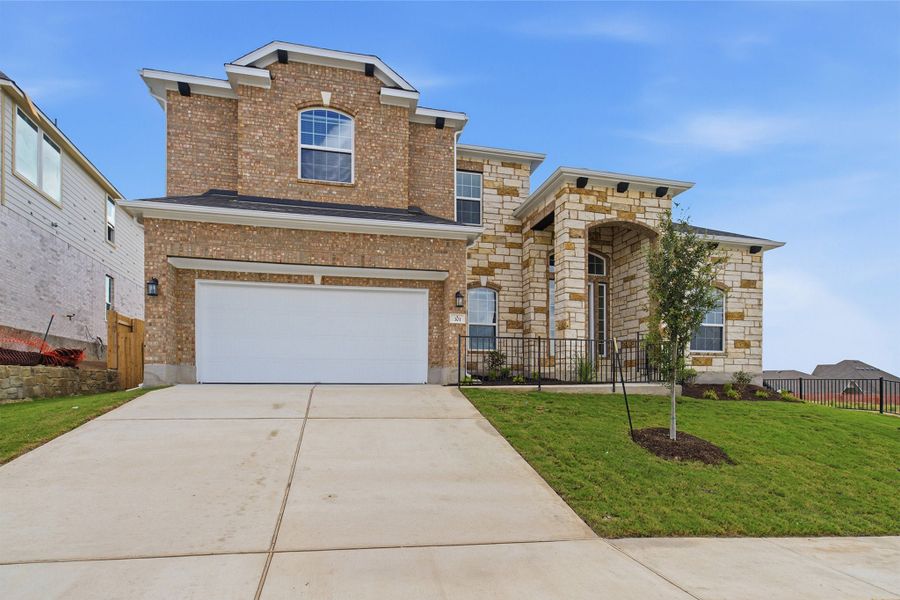 Front exterior of a new home in Sunfield, Buda, TX, highlighting curb appeal (Image 24). Front exterior of a new home in Sunfield, Buda, TX, highlighting curb appeal (Image 24).