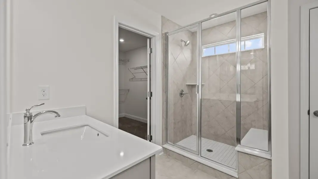 Modern bathroom with fully tiled walk-in shower and seat, in the Norris Design by DRB Homes at Lakeside Glen in York, SC Modern bathroom with fully tiled walk-in shower and seat, in the Norris Design by DRB Homes at Lakeside Glen in York, SC