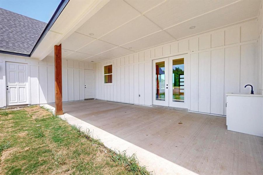 Property entrance with a patio area, sink, and french doors