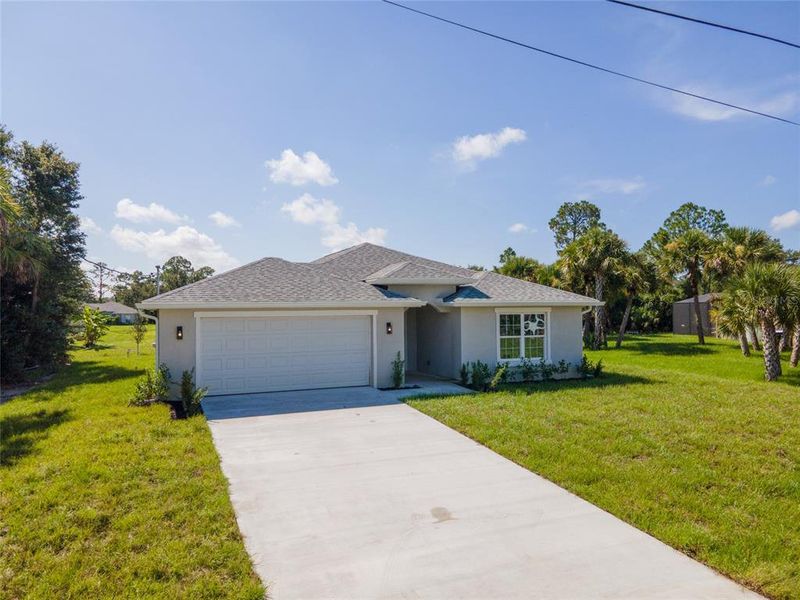 Front exterior of a new home in , North Port, FL, highlighting curb appeal (Image 18). Front exterior of a new home in , North Port, FL, highlighting curb appeal (Image 18).