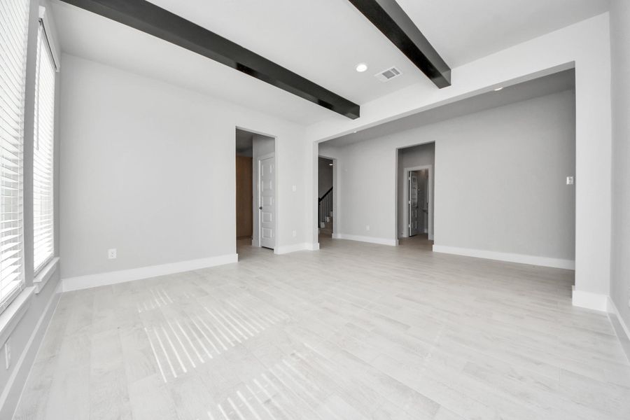 Craft enduring memories with loved ones around the table in this roomy dining area. It boasts stylish flooring, personalized paint, and is conveniently situated next to the family room and kitchen, fostering an open and inclusive ambiance.