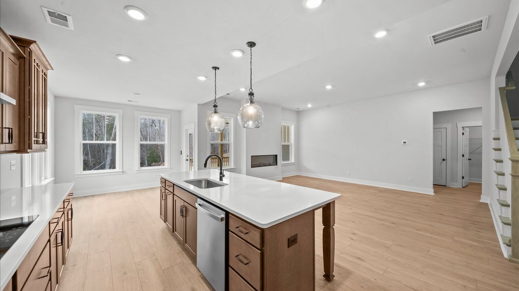 First-class gourmet kitchen with a spacious 9-foot island perfect for entertaining beneath designer pendant lighting